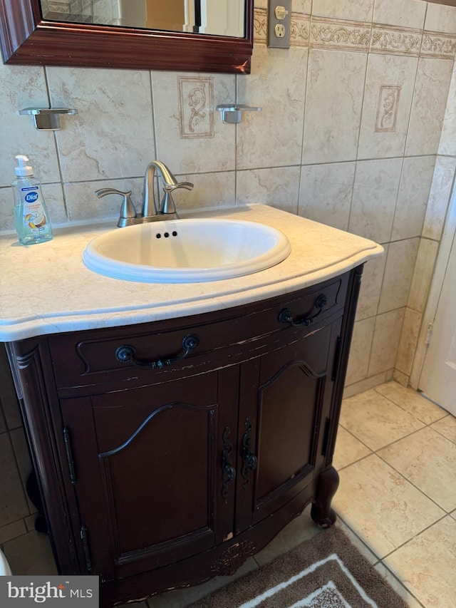 bathroom with tasteful backsplash, tile patterned floors, and vanity