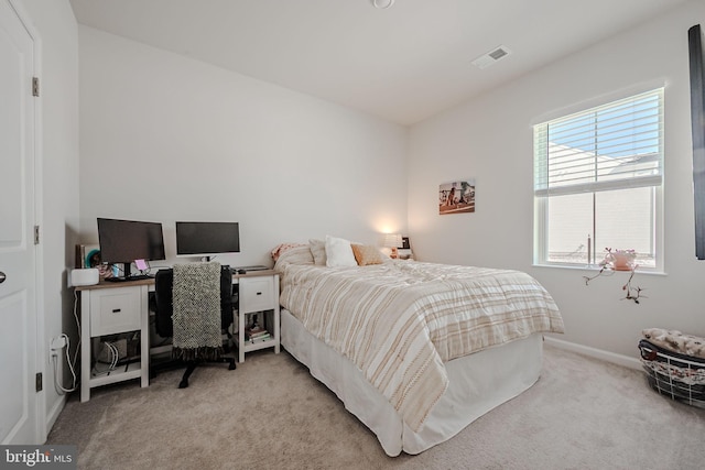 bedroom featuring light carpet