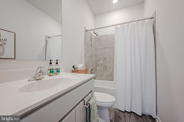 full bathroom featuring hardwood / wood-style floors, toilet, vanity, and shower / tub combo with curtain