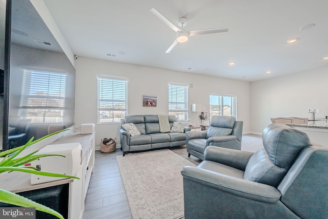 living room with ceiling fan and light hardwood / wood-style floors