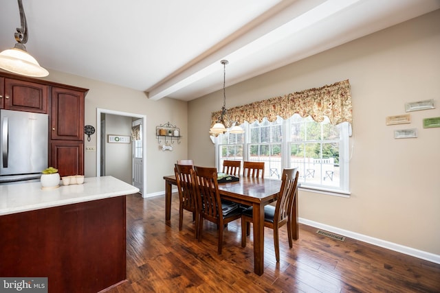 dining room featuring a chandelier, beam ceiling, and dark hardwood / wood-style flooring