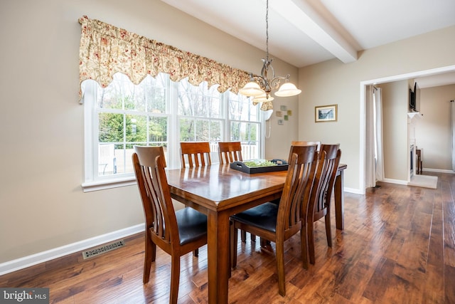 dining area with dark hardwood / wood-style flooring and beam ceiling