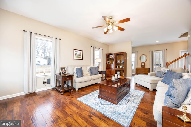 living room with ceiling fan and dark hardwood / wood-style flooring