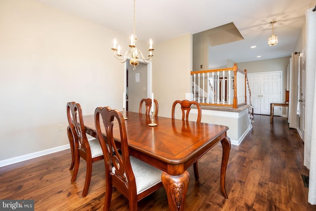 dining area featuring dark wood-type flooring and a chandelier