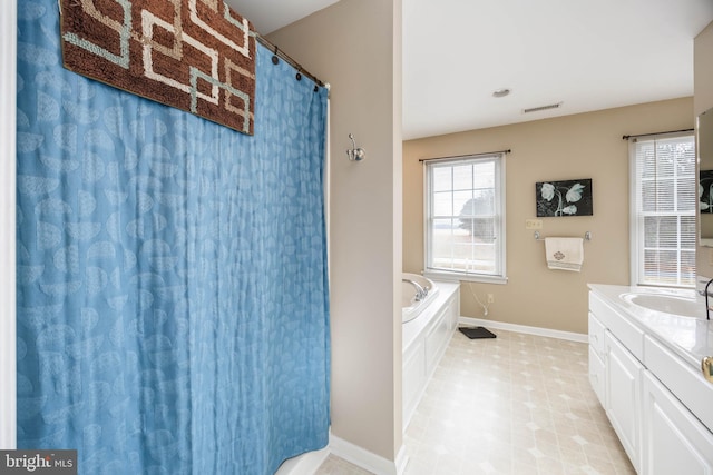 bathroom featuring vanity and a tub to relax in