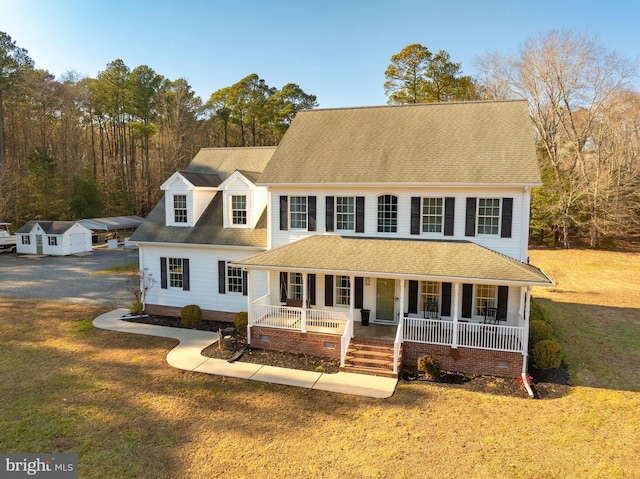 view of front of home featuring a front yard and covered porch