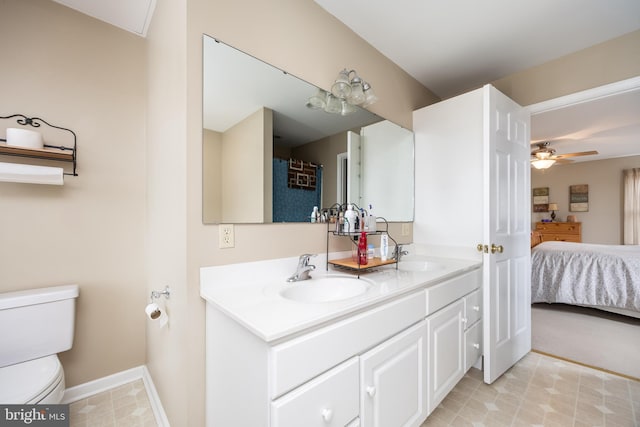 bathroom with vanity, ceiling fan, and toilet