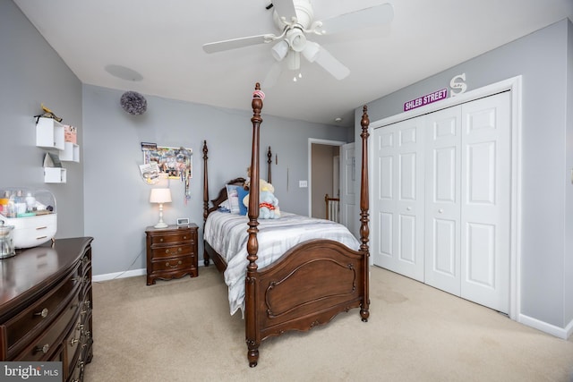 carpeted bedroom with ceiling fan and a closet