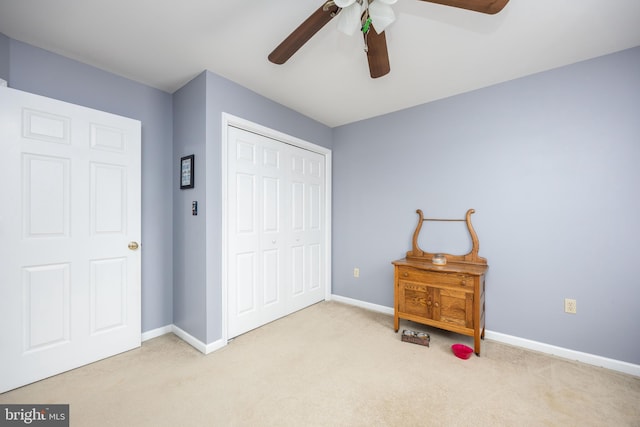 carpeted bedroom featuring a closet and ceiling fan