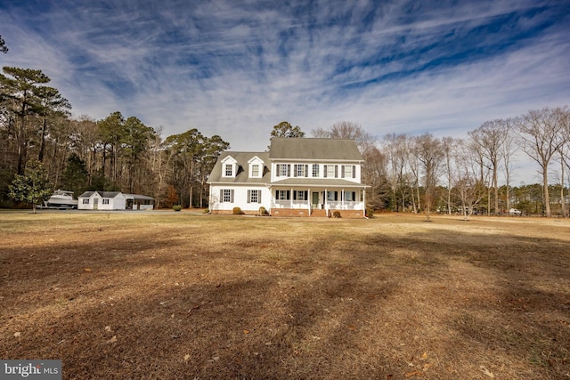 view of front of house with covered porch and a front yard