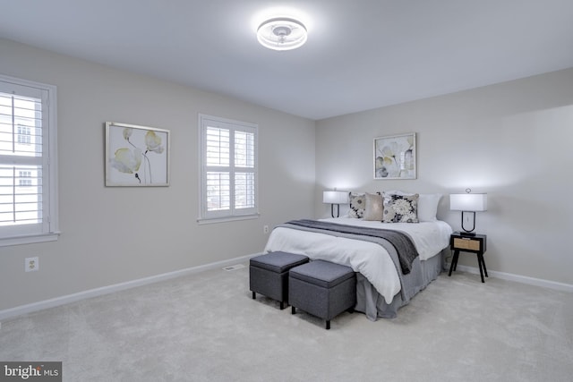 carpeted bedroom featuring baseboards