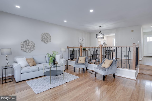 living area featuring recessed lighting, an inviting chandelier, and wood finished floors