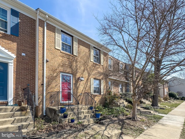 view of property featuring brick siding