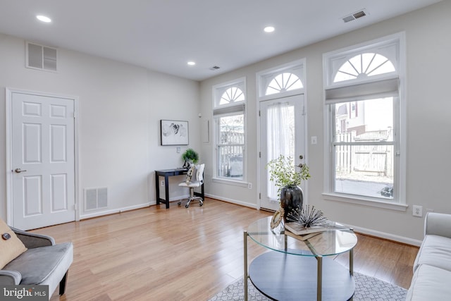 living area featuring visible vents, recessed lighting, and light wood-type flooring