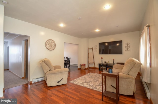 living room with baseboard heating and dark hardwood / wood-style flooring