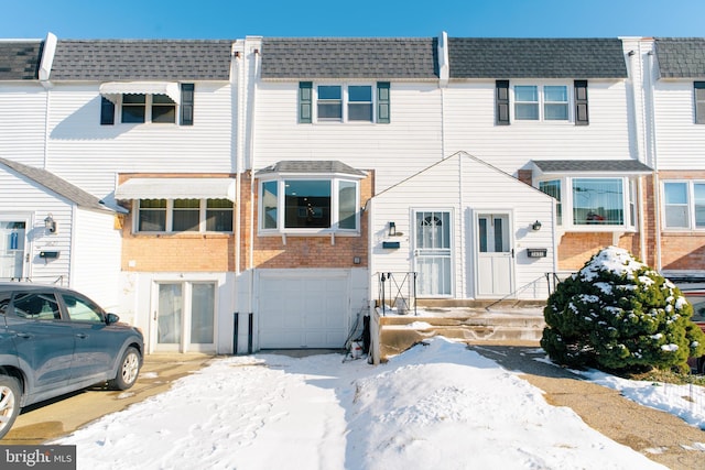 townhome / multi-family property featuring a garage