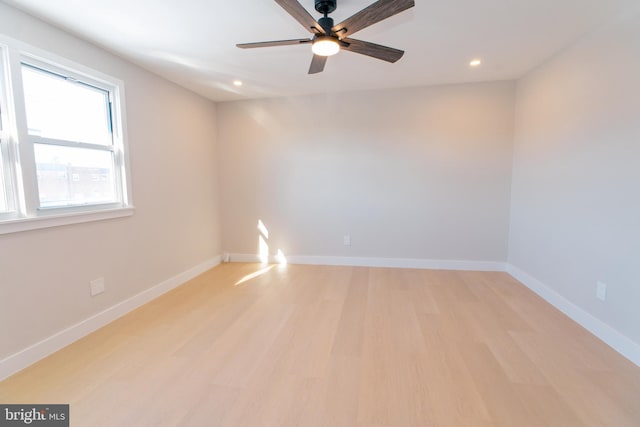 empty room featuring ceiling fan and light wood-type flooring