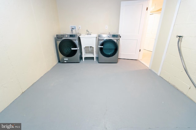 clothes washing area featuring independent washer and dryer