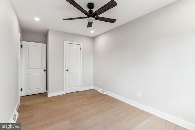 unfurnished bedroom with ceiling fan and light wood-type flooring