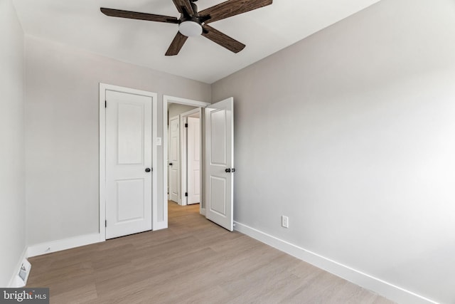 unfurnished bedroom with ceiling fan and light wood-type flooring