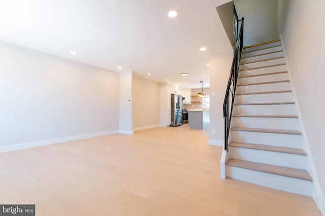 stairs with hardwood / wood-style floors