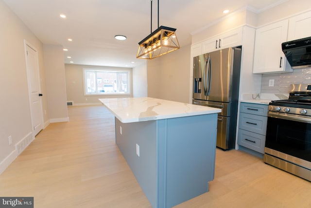 kitchen featuring white cabinetry, hanging light fixtures, stainless steel appliances, tasteful backsplash, and a kitchen island