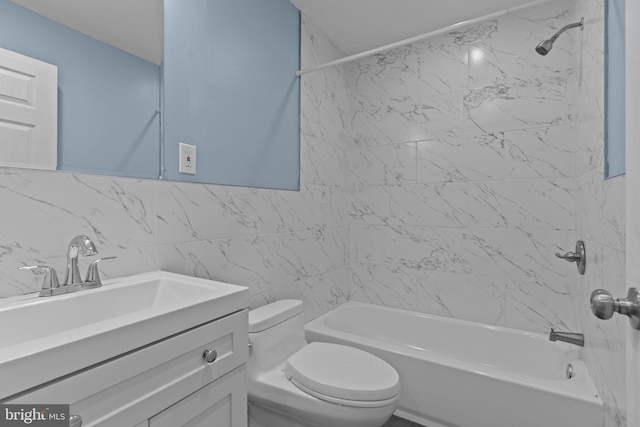 full bathroom featuring vanity, backsplash, shower / bath combination, tile walls, and toilet