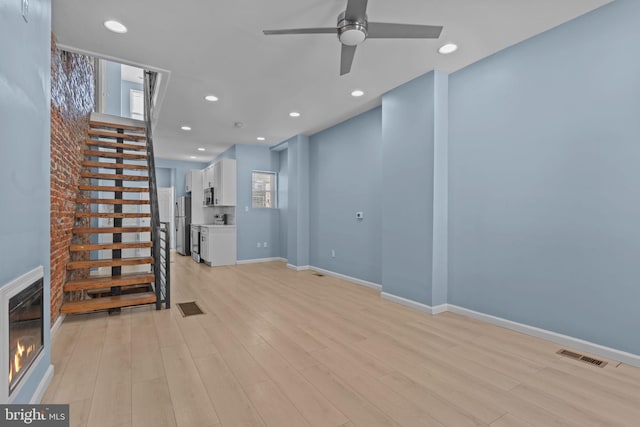 interior space with light hardwood / wood-style floors and ceiling fan