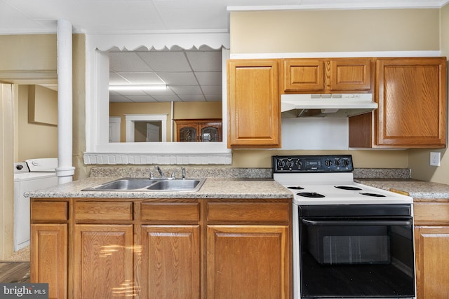 kitchen with electric stove, washer / dryer, sink, and a drop ceiling