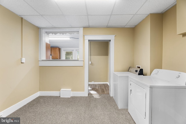 laundry area with light colored carpet and washer and clothes dryer