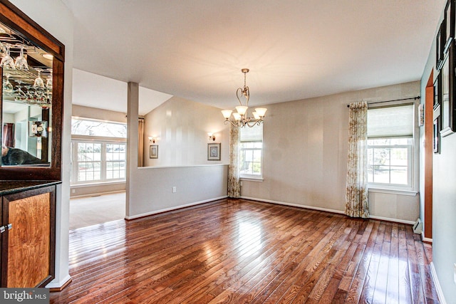 unfurnished dining area with hardwood / wood-style flooring and a healthy amount of sunlight