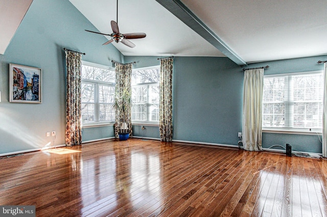 spare room featuring plenty of natural light, hardwood / wood-style floors, a ceiling fan, and vaulted ceiling