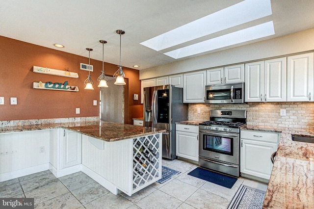 kitchen featuring visible vents, tasteful backsplash, stainless steel appliances, a peninsula, and stone counters