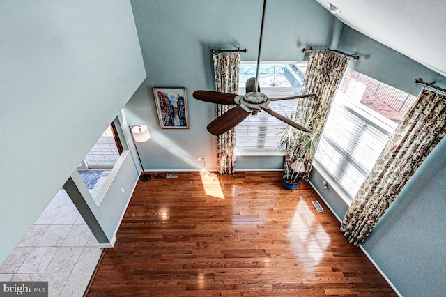 interior space featuring visible vents, baseboards, ceiling fan, and wood finished floors