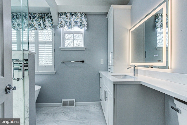 full bath with visible vents, baseboards, a freestanding bath, marble finish floor, and vanity