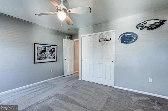 unfurnished bedroom with baseboards, visible vents, ceiling fan, a closet, and carpet flooring