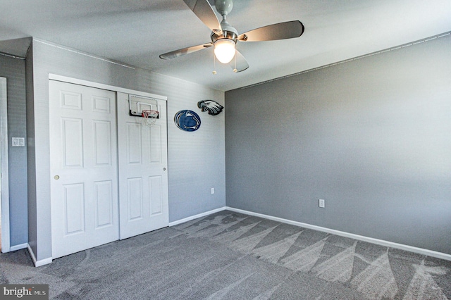 unfurnished bedroom featuring a closet, baseboards, carpet, and ceiling fan