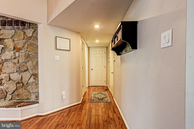 hall with wood finished floors and baseboards