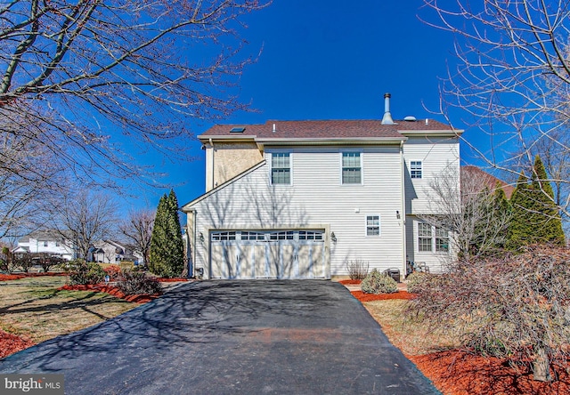 view of home's exterior featuring aphalt driveway and a garage