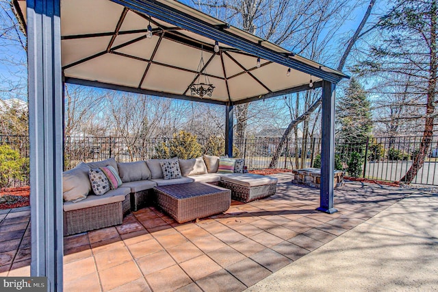 view of patio with a gazebo, outdoor lounge area, and fence