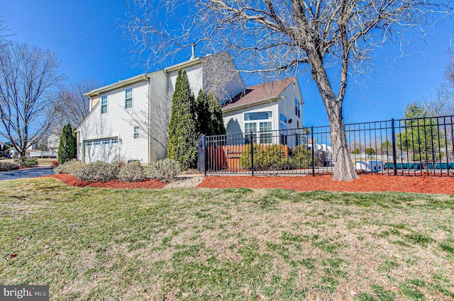 view of home's exterior with a lawn, a garage, and fence