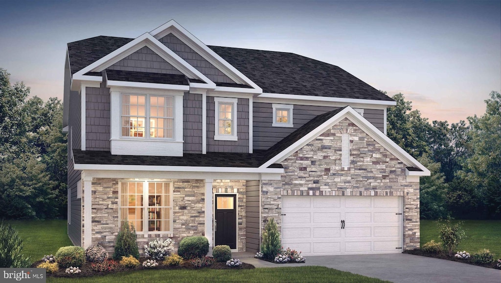 craftsman-style house with a garage and a lawn