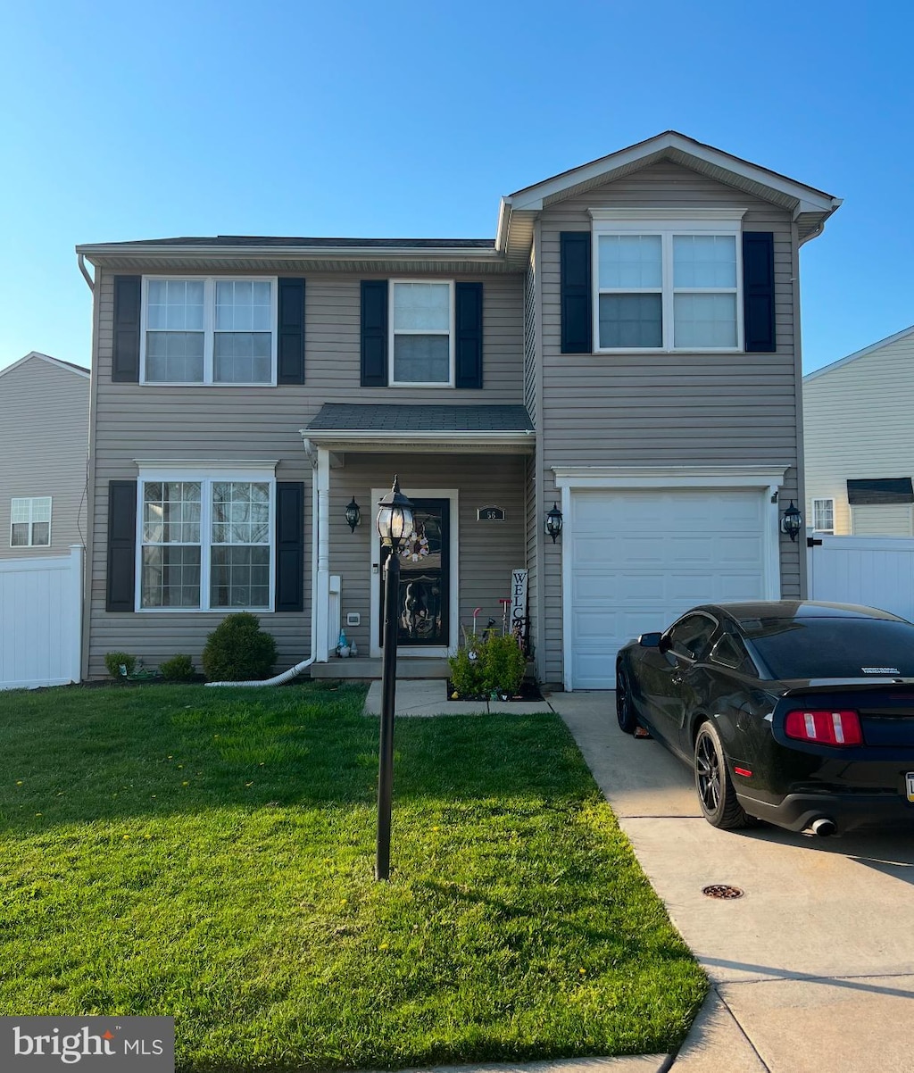 view of front of property featuring a garage and a front lawn