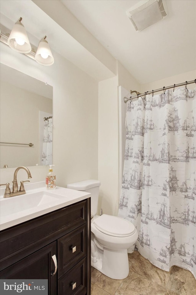 bathroom with vanity and toilet