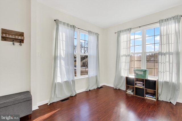 interior space with plenty of natural light and dark wood-type flooring