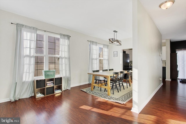 dining area featuring dark hardwood / wood-style floors and a chandelier