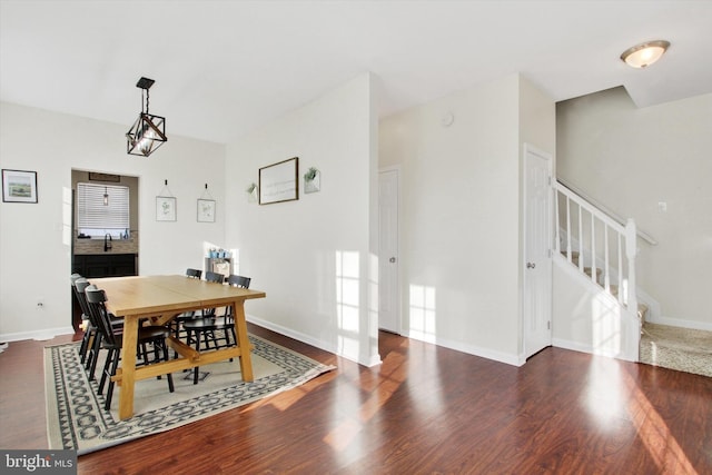 dining area featuring dark wood-type flooring and sink