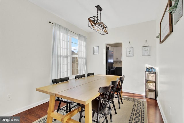 dining space with wood-type flooring