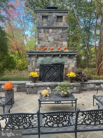 view of patio with an outdoor stone fireplace