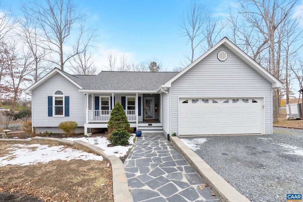 137 Jefferson Dr, Lake Monticello, VA 22963 - ranch-style house with covered porch, driveway, an attached garage, and a shingled roof